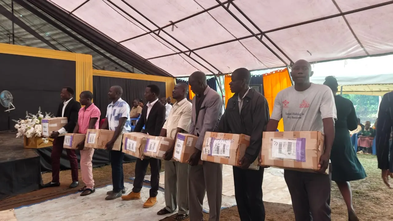 Community representatives receiving boxes at a church gathering